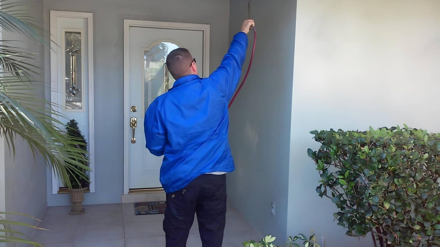 Pest control service treating exterior of home in Clearwater